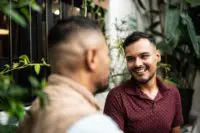 Two people smiling at each other.